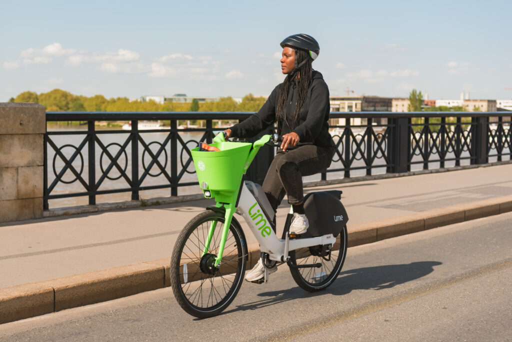 Photo of woman riding an e-bike on a bridge