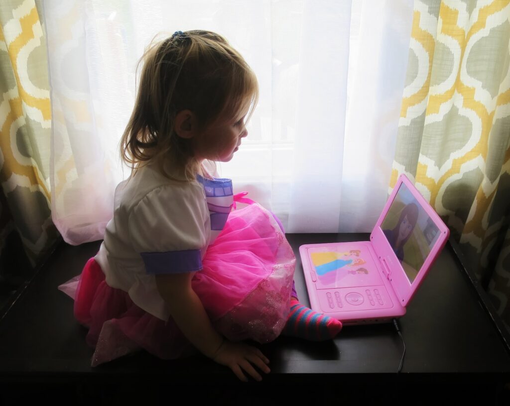 a young girl using a laptop