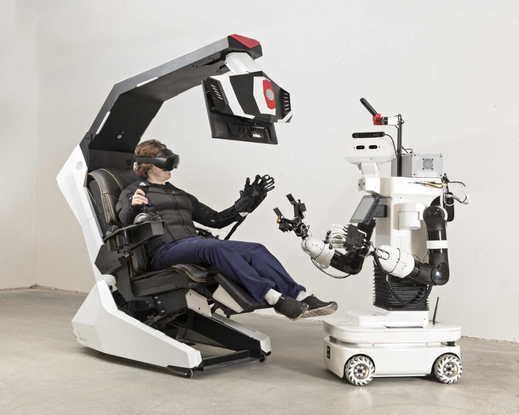 Operator in chair with Valkky robot, copyright Forum Virium Helsinki