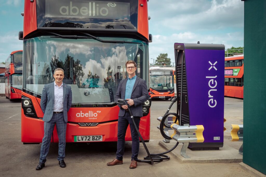 Jon Eardley (left) with a new Electroliner bus and charge point at Twickenham bus depot, photo courtesy of UK Power Networks