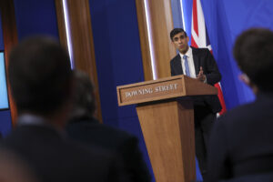 Rishi Sunak at a podium for a press conference