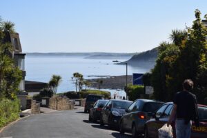 cars parked on parking lot near sea during daytime