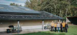 Staff and tenants with the solar PV systems installed at Blakemere Village, Cheshire