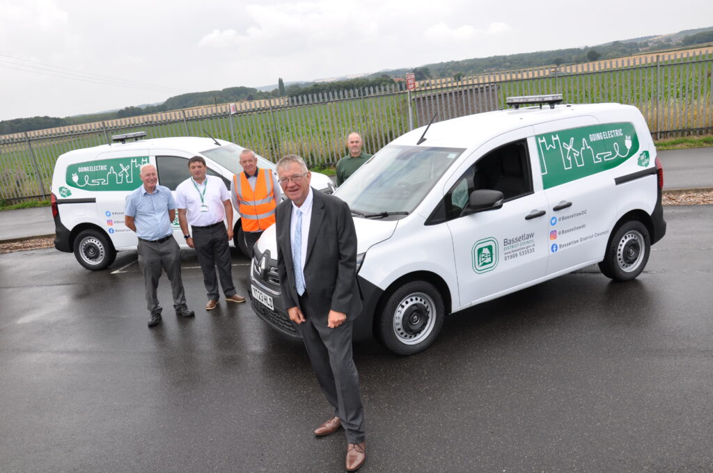 Cllr Darrel Pulk with two of the new EVs, photo courtesy of Bassetlaw District Council