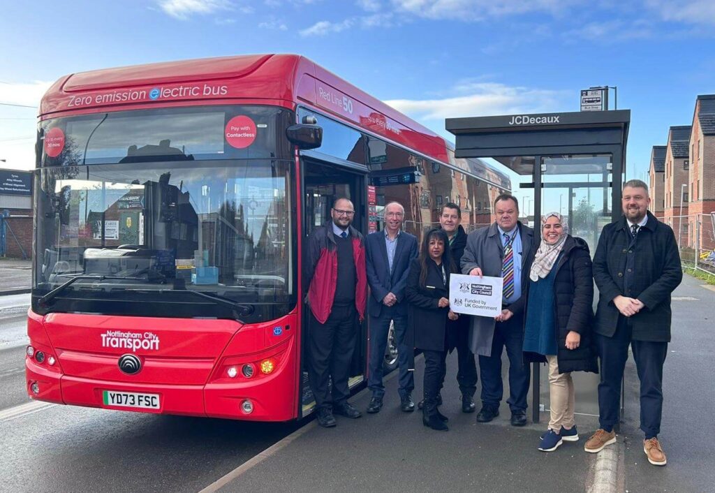 Cllr David Mellen (in striped tie) attends the launch of the new Red Line 50 electric bus service