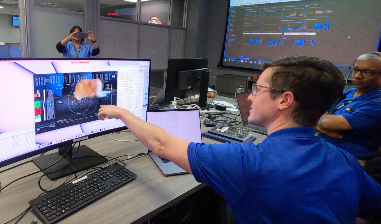 Photo showing Ryan Rogalin, DSOC Receiver Electronics Lead at NASA JPL, at JPL, working in the mission support area as the video of Taters is received. Image: NASA/JPL-Caltech