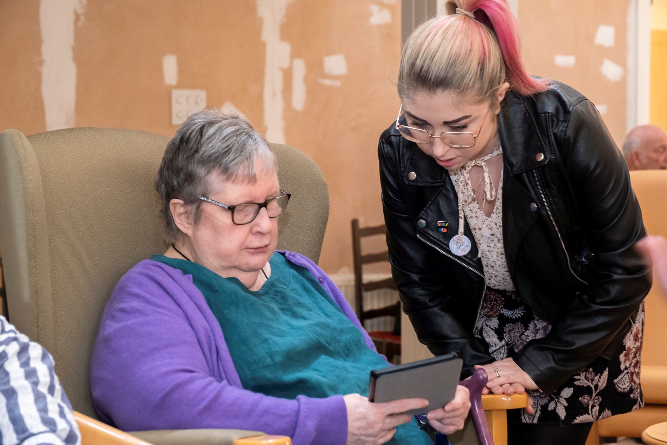 Resident and carer using a tablet as part of technology-enabled care, photo courtesy of ADASS/TSA