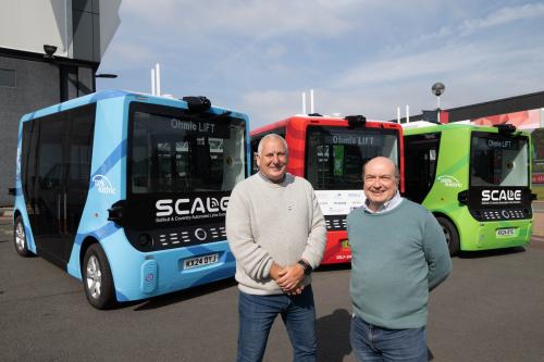 Mark Cracknell (Programme Director at Zenzic) and Cllr Andy Mackiewicz (Cabinet Member for Climate Change & Planning at Solihull Metropolitan Borough Council) with automated buses from the SCALE project