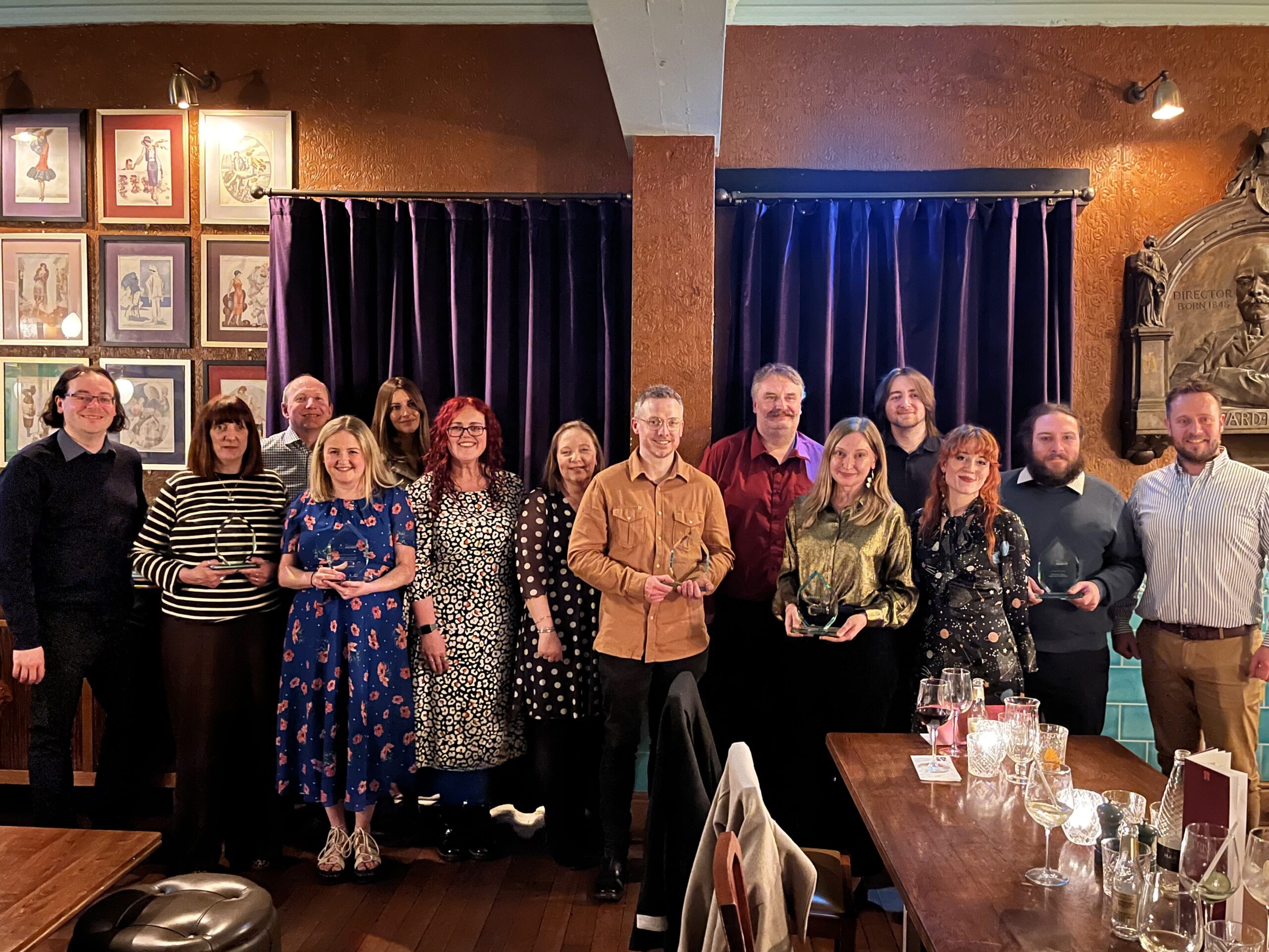 Winners of the 2026 Granicus UK Digital Government Awards. Left to right: James McCarthy, Kay O'Flaherty and Rob Griffiths (back row) from Wrexham; Ceri Parsons from Rhondda; Jennifer Roberts (back row) from Wrexham; Zoe Lancelott from Rhondda; Lianne Tew, Simon Mugridge and Brett Levett from Wealden; Daisy Fox Smith from Cafcass; Danny Woolven (back row) from Wealden; Beth Hamilton from Cafcass; Christopher Philpot and James Hurrell from Tower Hamlets. 