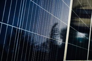 Close-up of wet solar panels reflecting sky